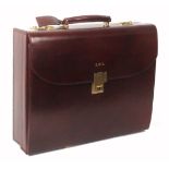 Asprey - London, a burgundy leather rectangular attache case, unused, initialled 'GWQ', the top with