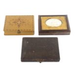 Three rectangular sewing companions, comprising a leatherette example, the engraved brass lid