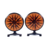 A pair of rosewood miniature circular tilt top tables, each with a tri-form base and three bun