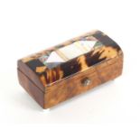 An early 19th Century tortoiseshell needle packet box, the domed lid inlaid with a panel of mother