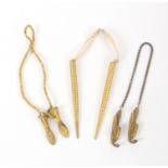 Three pairs of gilt metal knitting needle protectors, comprising a pair formed as lady's ice skates,