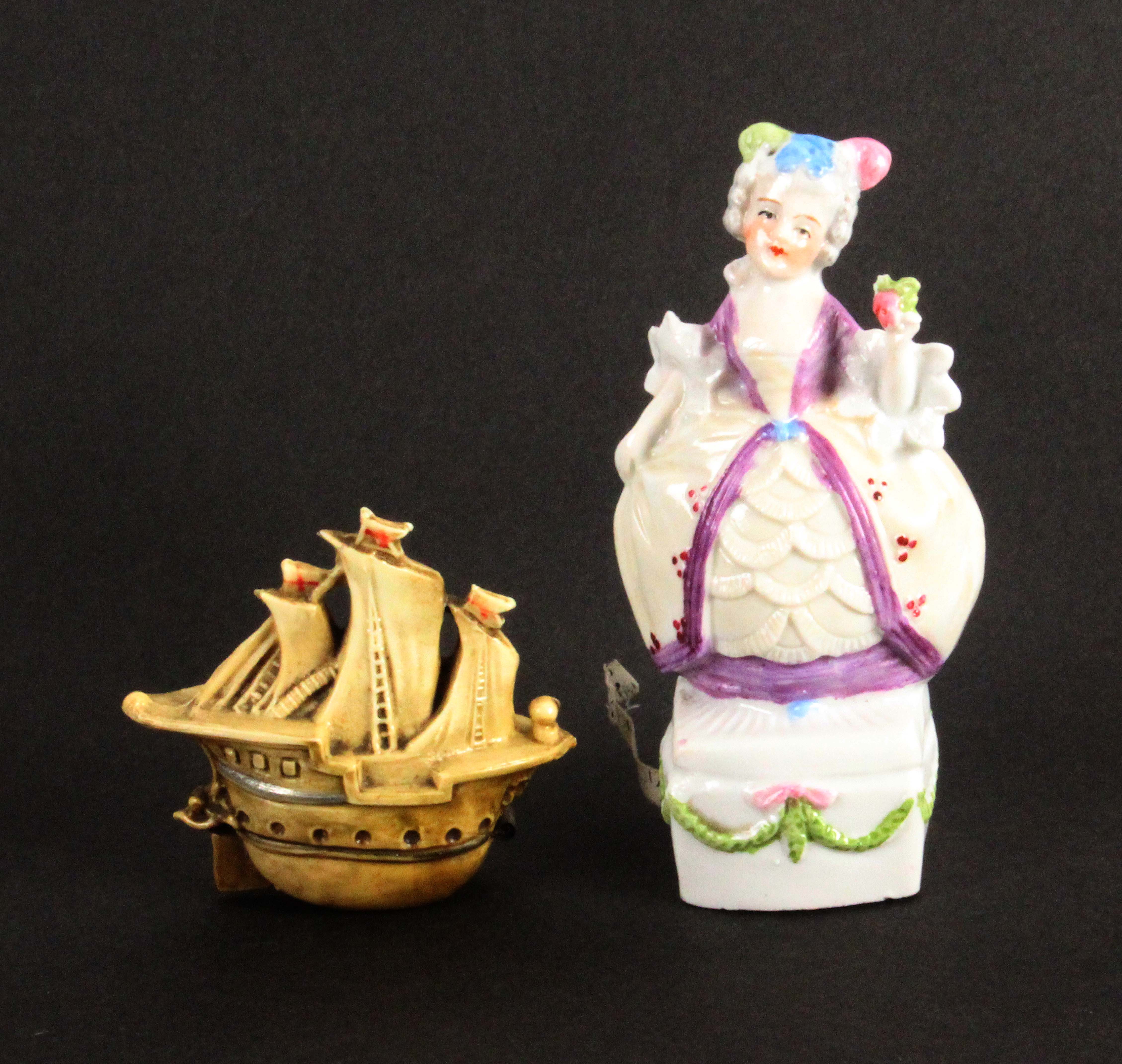 Two novelty tape measures, comprising a celluloid example in the form of a galleon, complete