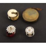 Four tape measures, comprising a mother of pearl and gilt metal bird cage example, inked tape