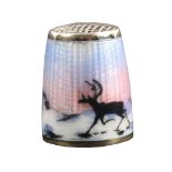 A Norwegian silver and enamel thimble, depicting two reindeer on the move against a winter landscape