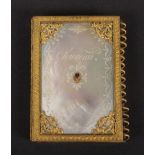 A Palais Royal 'Souvenir' notelet case, gilt flower head spine, the mother of pearl cover centred by