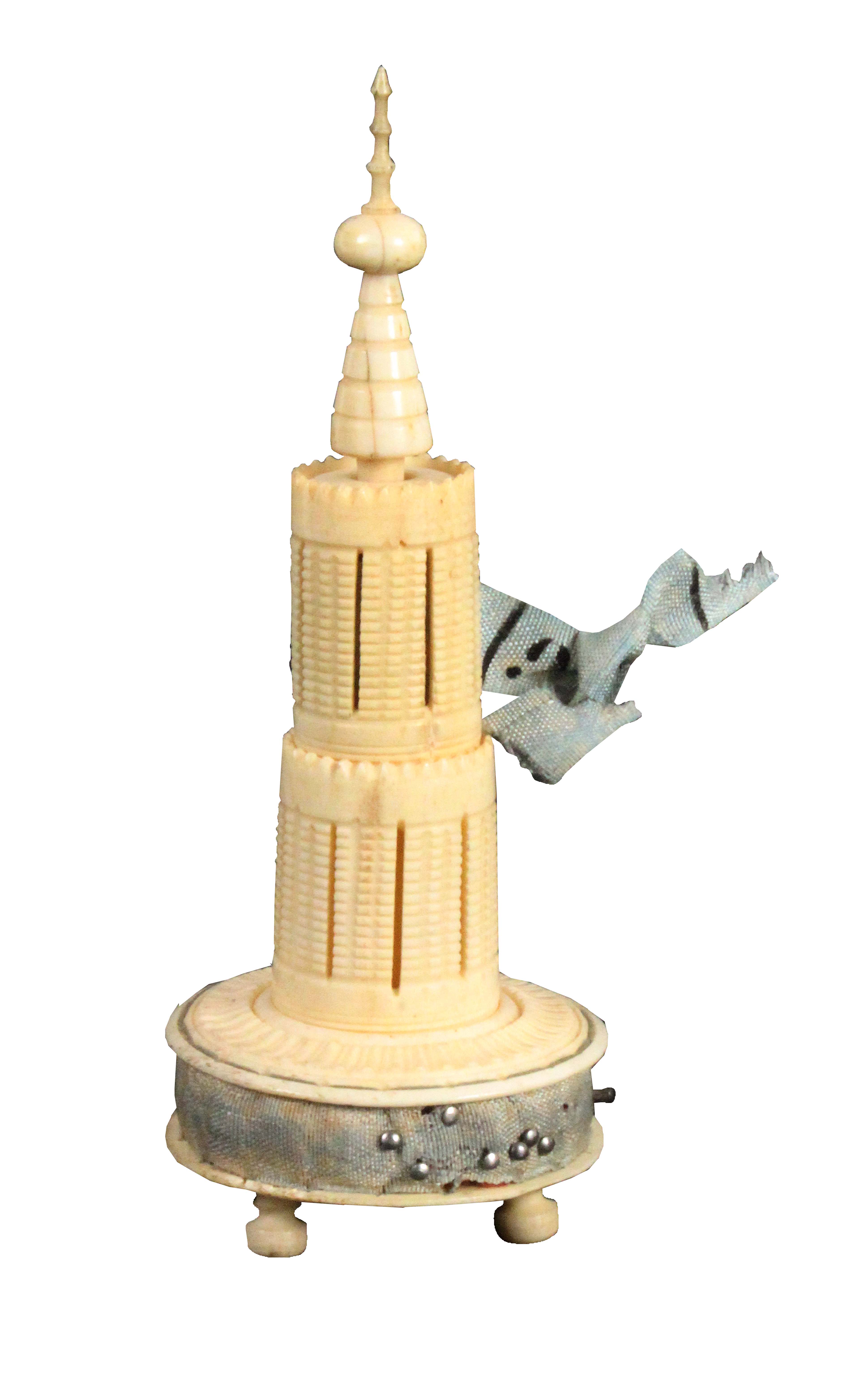 An early 19th Century turned ivory sewing tower, the circular base on three ball feet and fitted