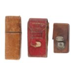 Three leather needle packet boxes and cases, comprising a red leather example titled 'Needles',