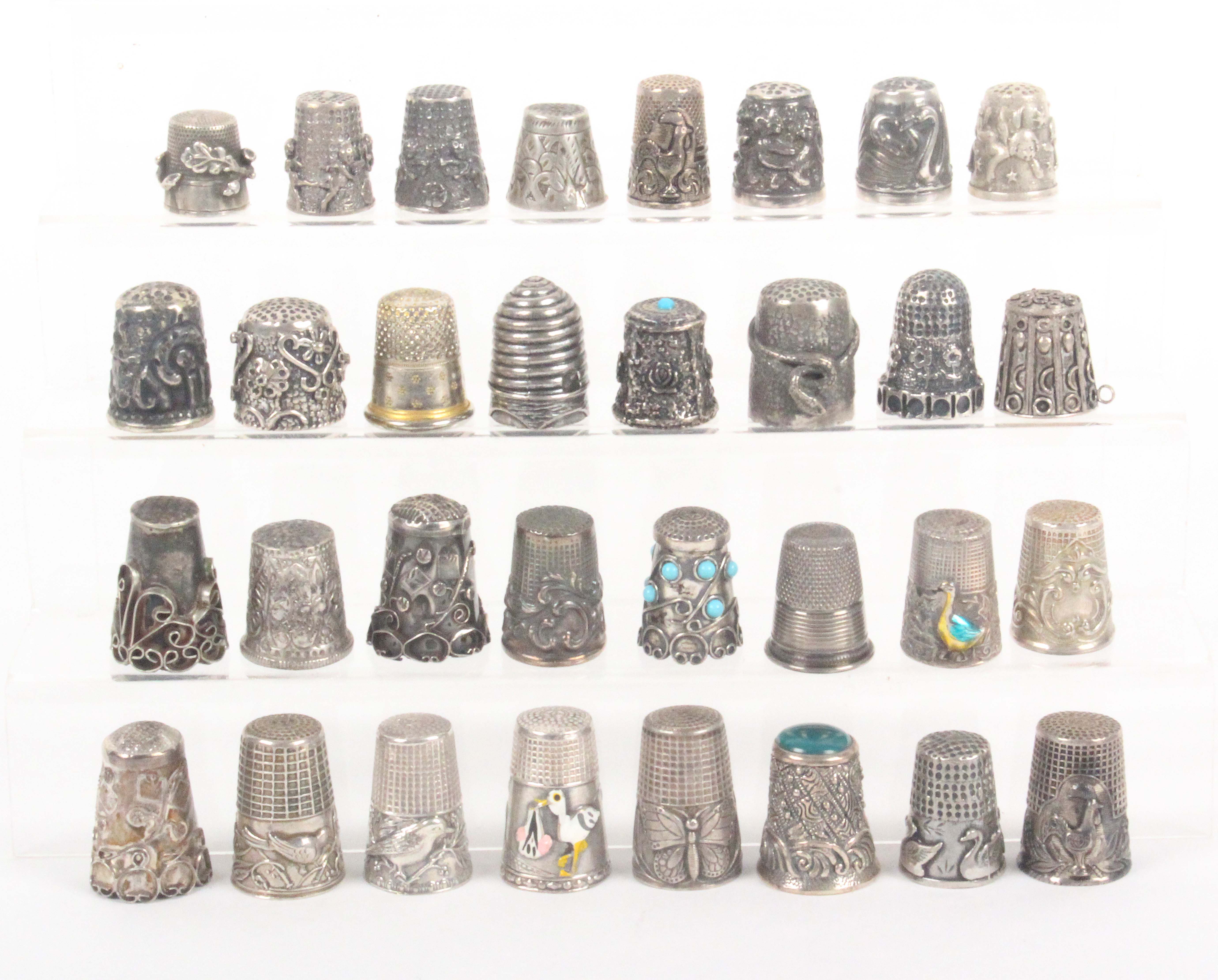 Thirty two continental silver and other thimbles, mostly with decorative friezes including Mexican