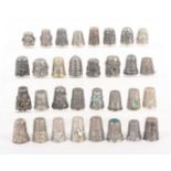 Thirty two continental silver and other thimbles, mostly with decorative friezes including Mexican