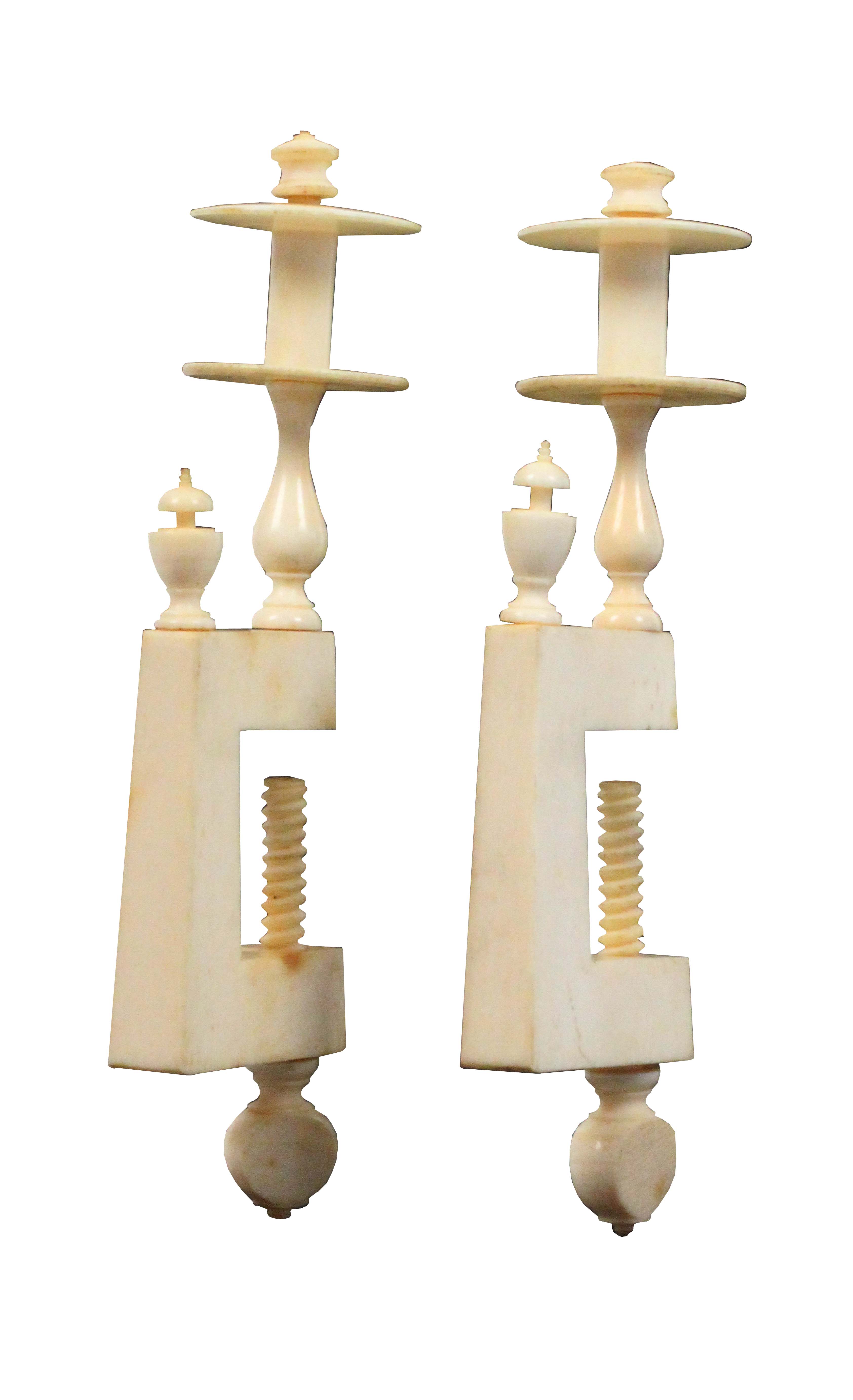 A pair of early 19th Century ivory sewing clamps, the slightly tapering rectangular frames each with