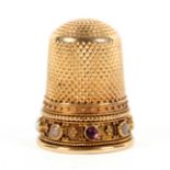 An attractive Victorian gold thimble, the frieze set with seven variously coloured pearls and a ruby