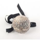 An unusual silver thread ball holder, of ball form with hinge and decorated with scrolls, flowers
