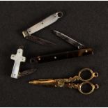 Miniature items, comprising three folding knives and a pair of scissors, the knives comprising a