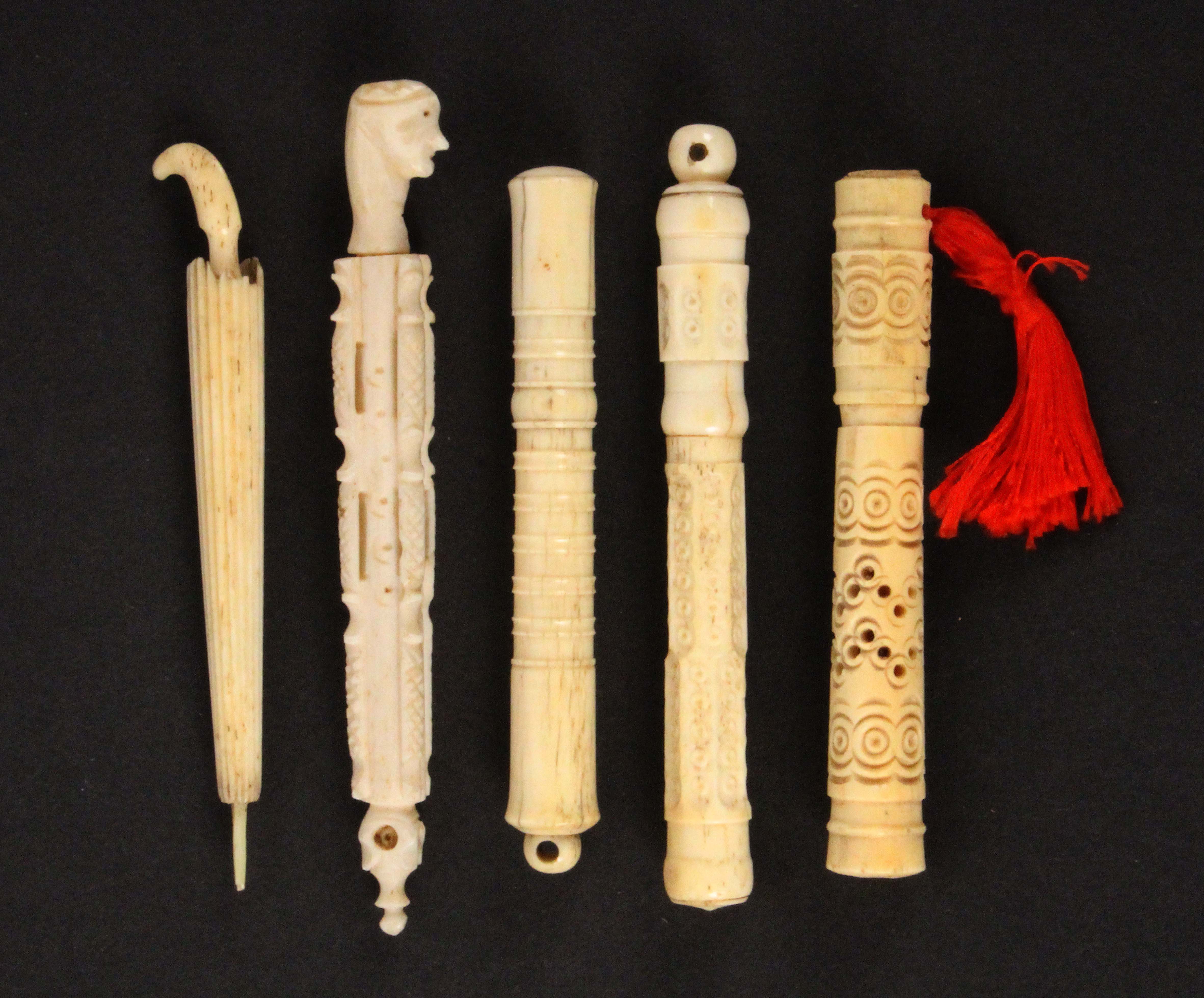 Five 19th Century bone and ivory needle cases, comprising an example as a furled umbrella, losses to