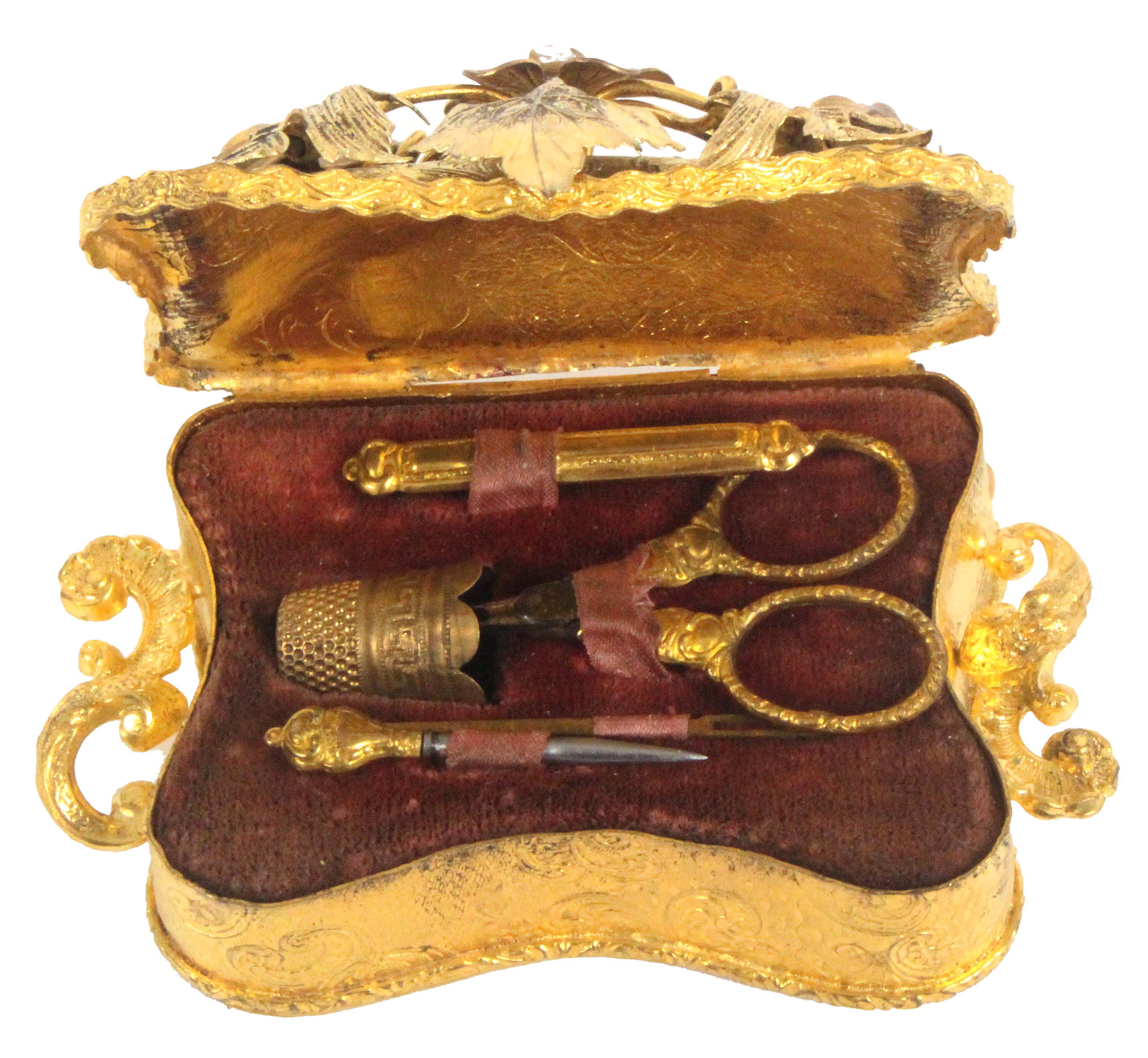 An elaborate French gilded metal sewing set for a child, or doll,circa 1870, the case of inward