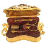 An elaborate French gilded metal sewing set for a child, or doll,circa 1870, the case of inward