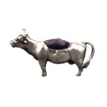 A silver pin cushion in the form of a standing cow, Birmingham, 1905 by Levi and Salaman, 5.5cms.