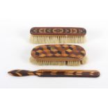 Tunbridge ware - three pieces, comprising a curved top brush with cube work panel, some bristles