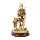 A late 19th Century Japanese sectional ivory figure group of a man and a child, both standing, the