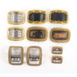 Five pairs of 19th Century shoe buckles, all with decorative gilt frames, two pairs with black