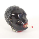 A novelty celluloid tape measure, in the form of a black boys head, the tape emerging from his mouth