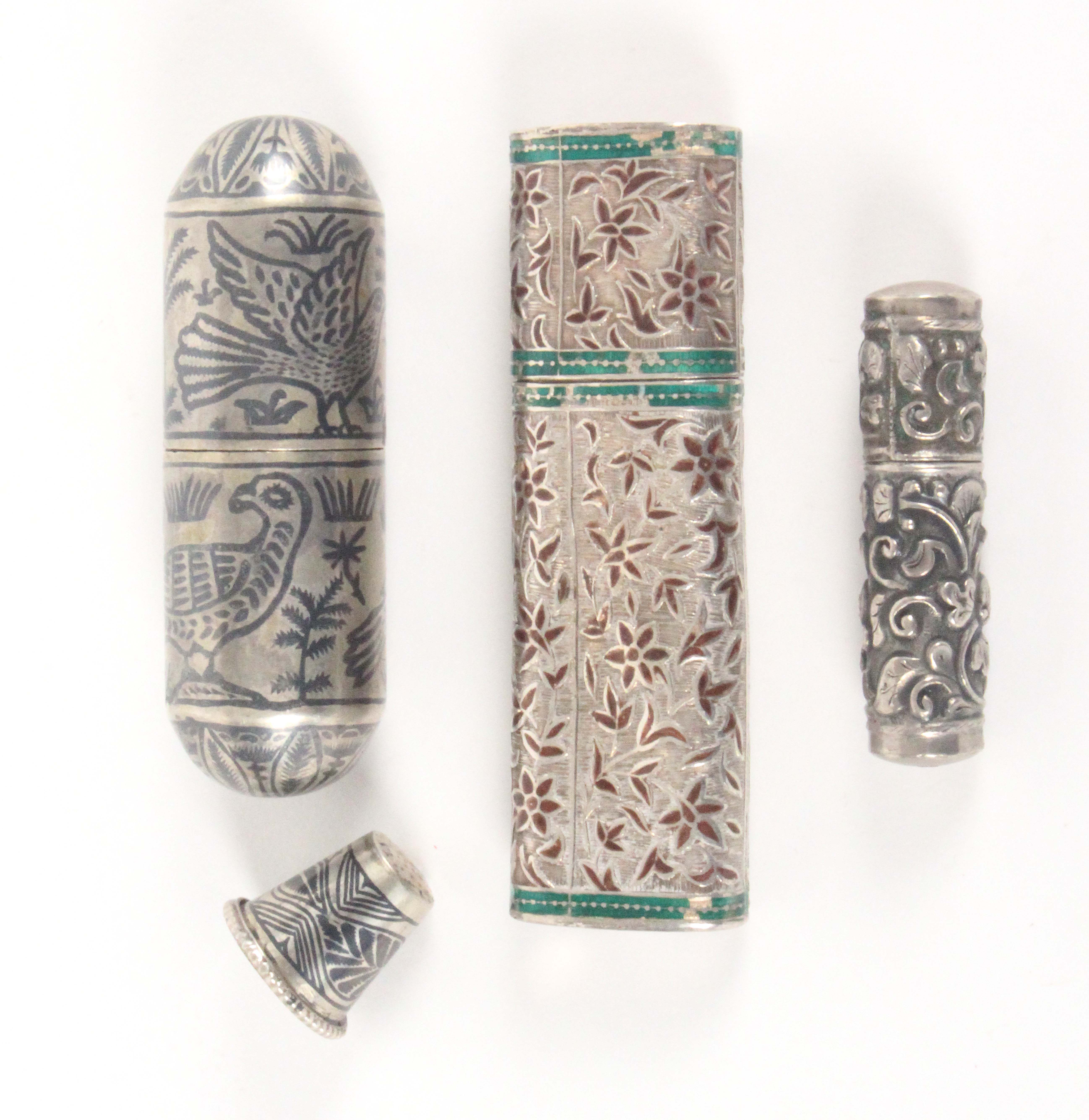 Three silver bodkin and needle cases, comprising a niello decorated cylinder example with domed