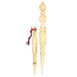 Two 19th Century ivory reversible stilettos, comprising a leaf carved example with pineapple finial,