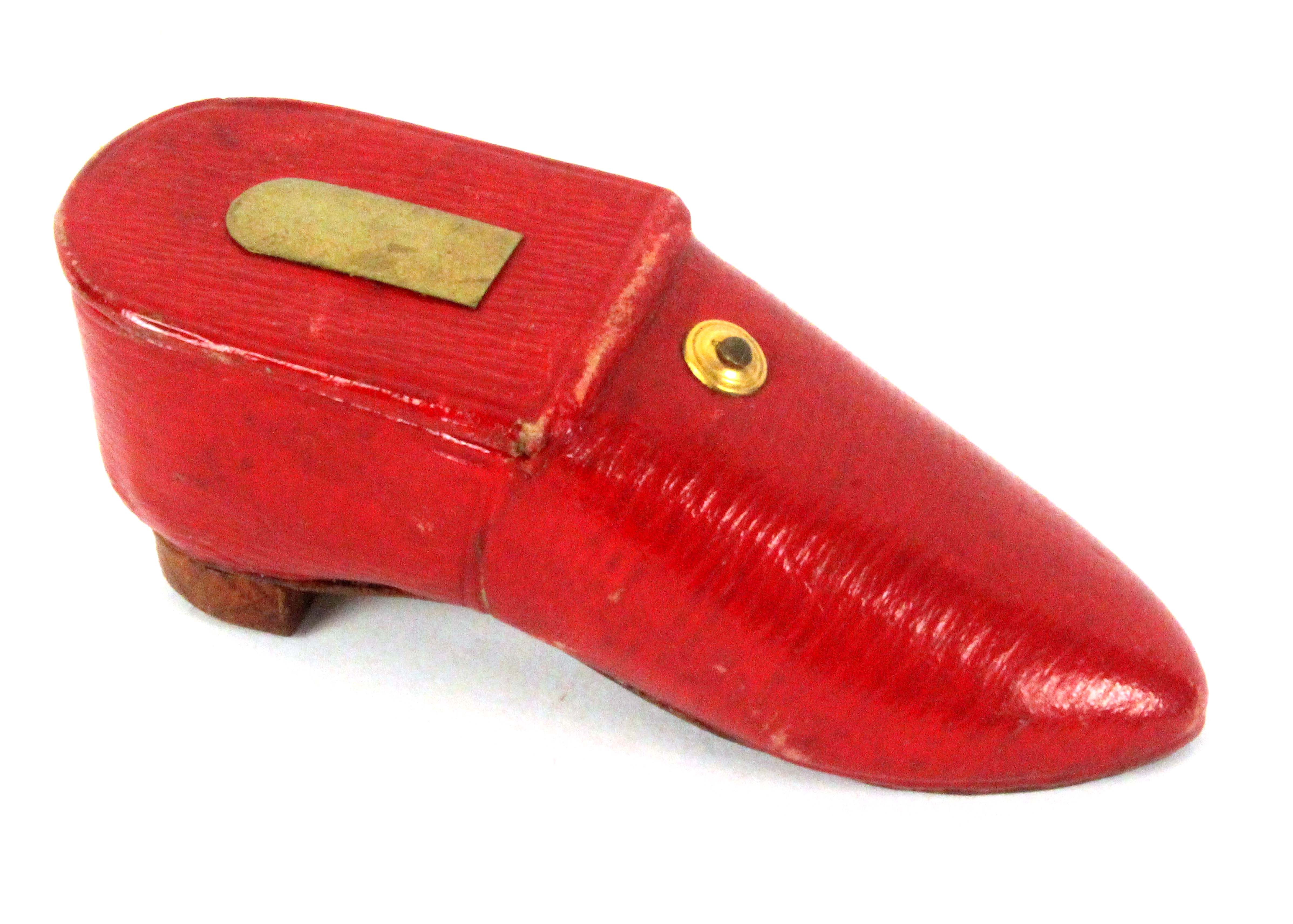 A Georgian red leather needle packet box in the form of a lady's shoe, hinged cover with gilt