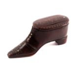 An early 19th Century mahogany shoe form snuff box, the flattened toe cap with Maltese cross style