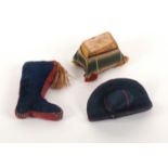 Three attractive material pin cushions, a red and blue silk hat, 5.5cms, a velvet and silk boot,