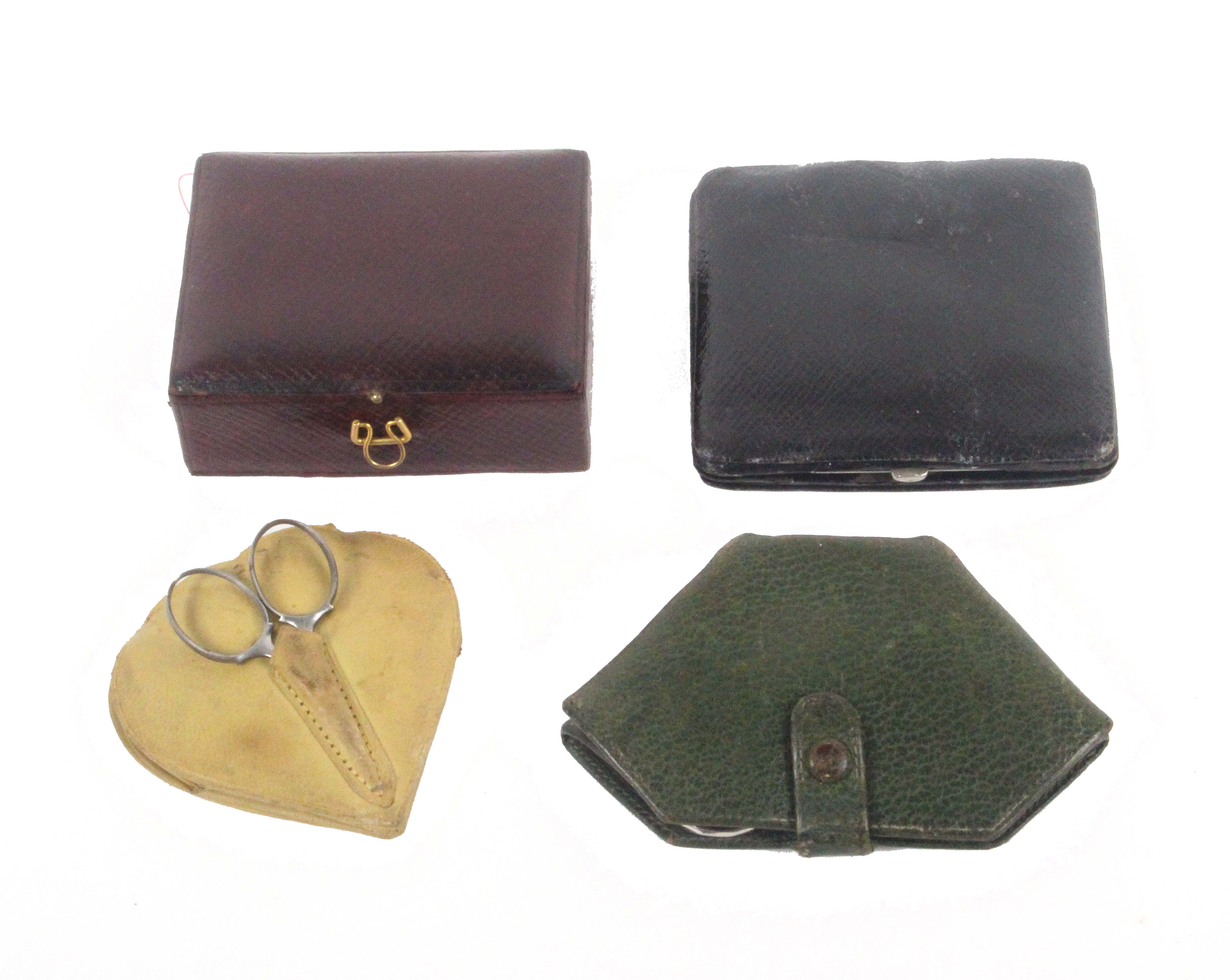 Four small leather sewing companions, each with a selection of tools and accessories, largest 9cms.