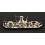 A miniature four piece silver tea set and tray, Birmingham, 1950 by Barker Brothers Silver Ltd.,