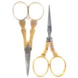 Two pairs of French gold handled scissors, both with steel blades comprising a pair with leaf