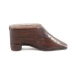 An early 19th Century rosewood shoe form snuff box, the flattened pointed toe below brass pique