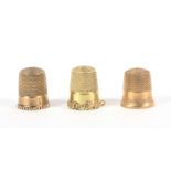 Three American thimbles, comprising a 10k gold example by Stern Brothers with leaf and ball frieze