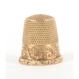 An American 14k gold thimble, by Ketcham and McDougall the scroll decorated frieze with vacant