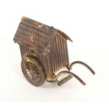 A scarce gilt brass novelty tape measure in the form of a bathing cart, the replacement tape wound