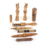 Nine wooden needle cases, including a pair of Tyrolean standing figural examples with small