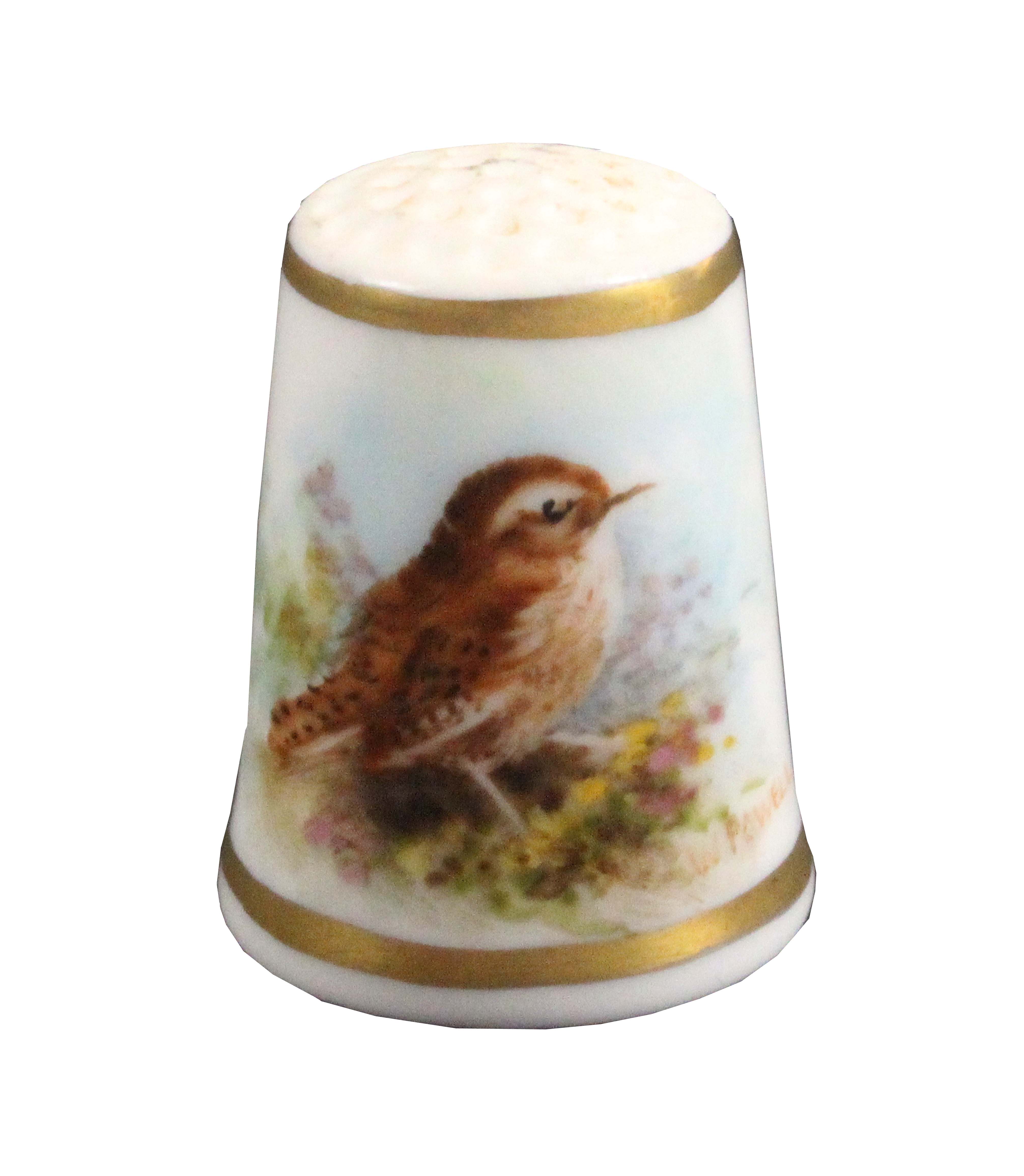 A Royal Worcester puce mark thimble, painted with a thrush on ground vegetation between gilt lines