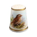 A Royal Worcester puce mark thimble, painted with a thrush on ground vegetation between gilt lines