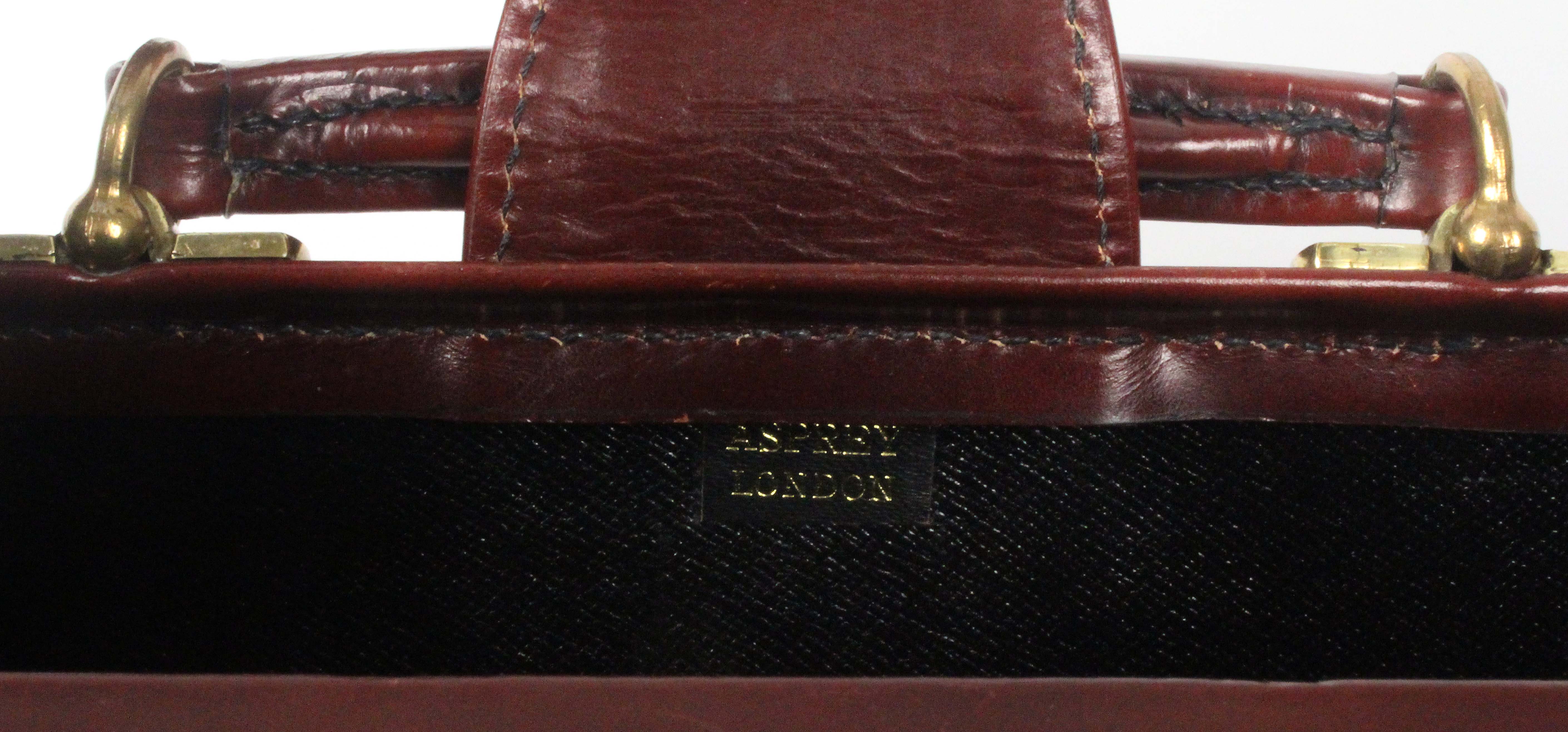 Asprey - London, a burgundy leather brief case, unused, initialled 'GWQ', brass lock, internal - Image 2 of 2