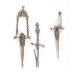 A pair of late 19th Century continental dagger scissors, sprung blades to a silver handle, the