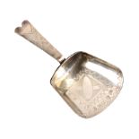 A silver caddy spoon, the shovel shaped bowl with bright cut internal panel the handle with