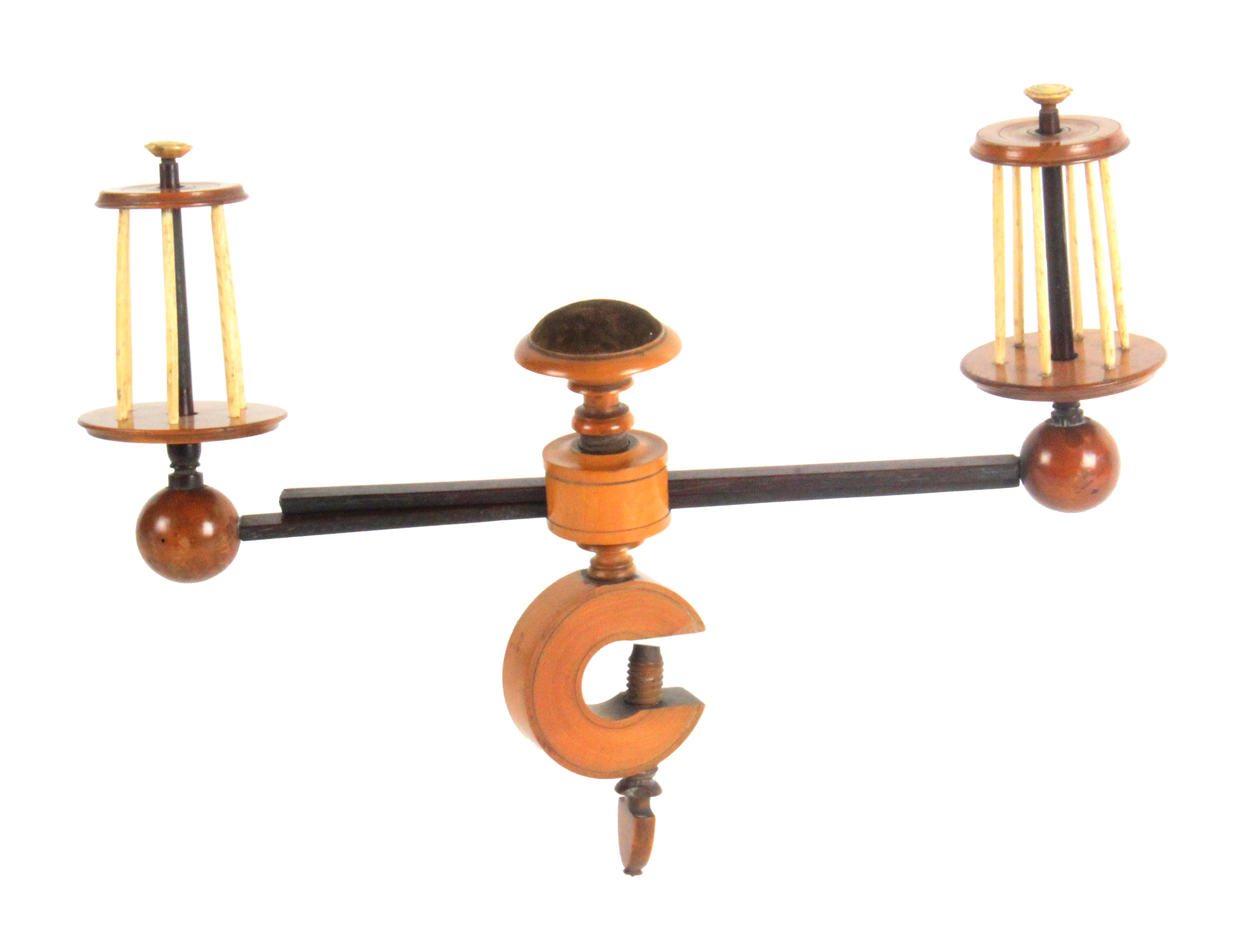 A boxwood, rosewood and bone winding clamp, the birdcage reels with turned tops and bases with