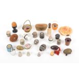 A collection of twenty three thimble and similar containers, in various materials, late 19th and