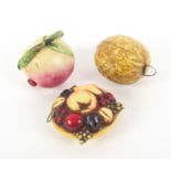 Three novelty celluloid tape measures, comprising a plum, the tape end as a ladybird, 4cms, a