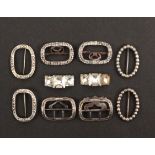 Five pairs of silver mounted small shoe buckles, comprising an oval pair with hinged pin fixings,