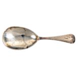 A silver caddy spoon, the tear shaped bowl engraved with a leaf and shield shaped panel, the