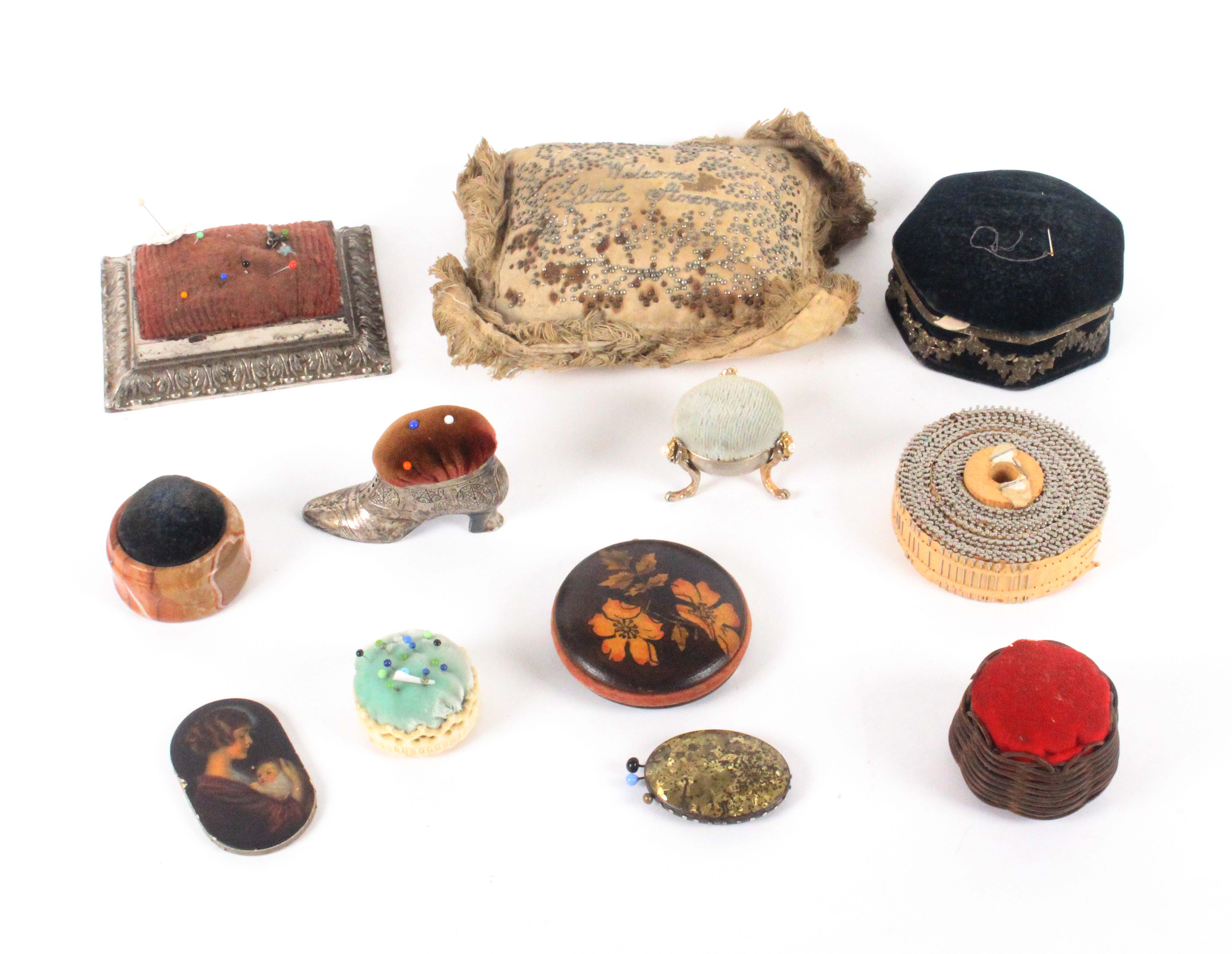 Twelve pin cushions and pin retainers, including a late 18th Century layette example inscribed '