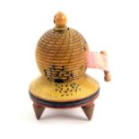 An early Tunbridge ware painted white wood tape measure in the form of a bee skep, repaired old tape